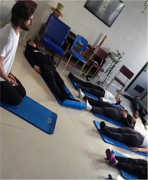 Young people participating in a yoga and meditation session as part of a youth program at Camp Lift